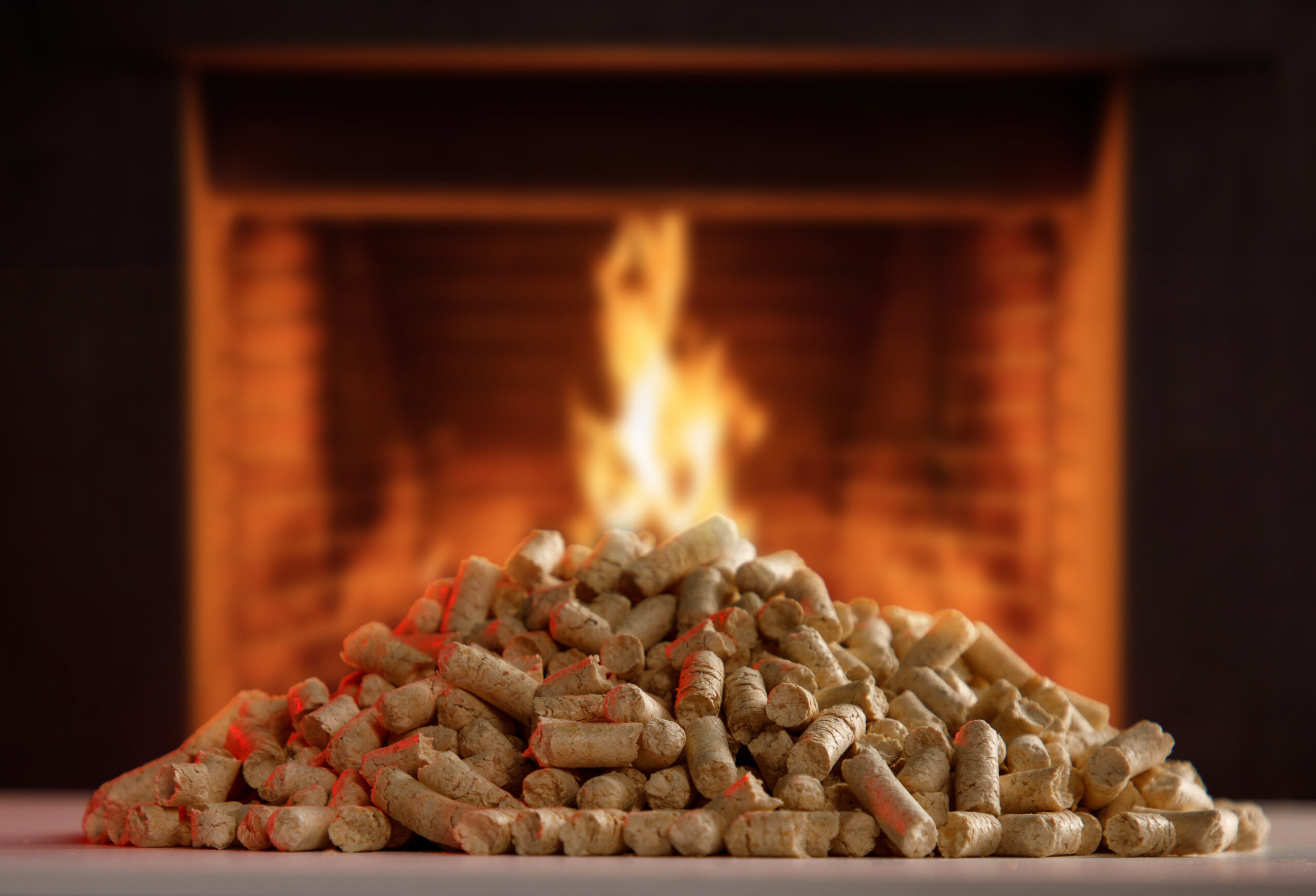 Fireplace burning firewood, fire flames on wood logs, bricks bac